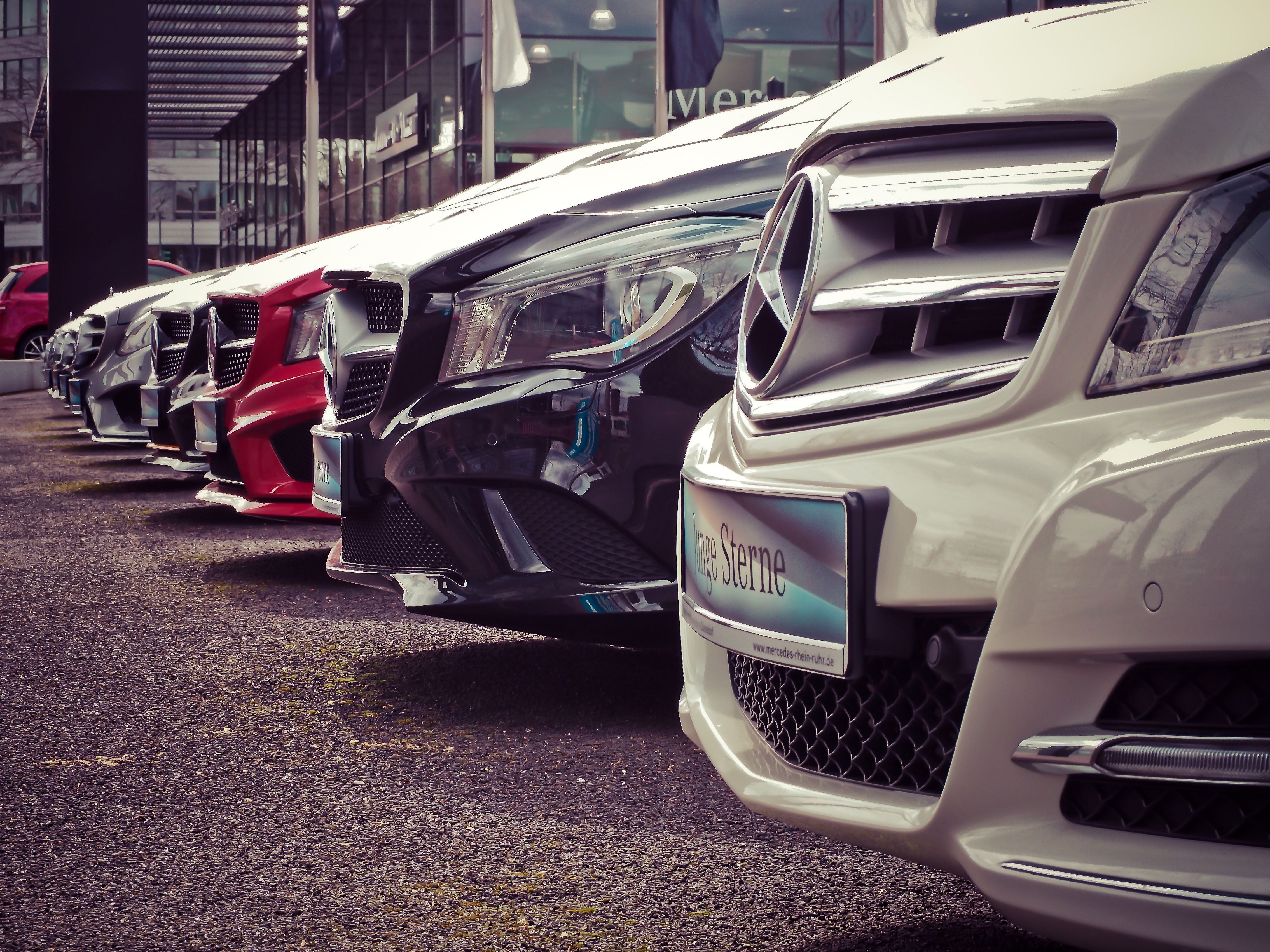 Modern car being loaded onto professional auto transport carrier